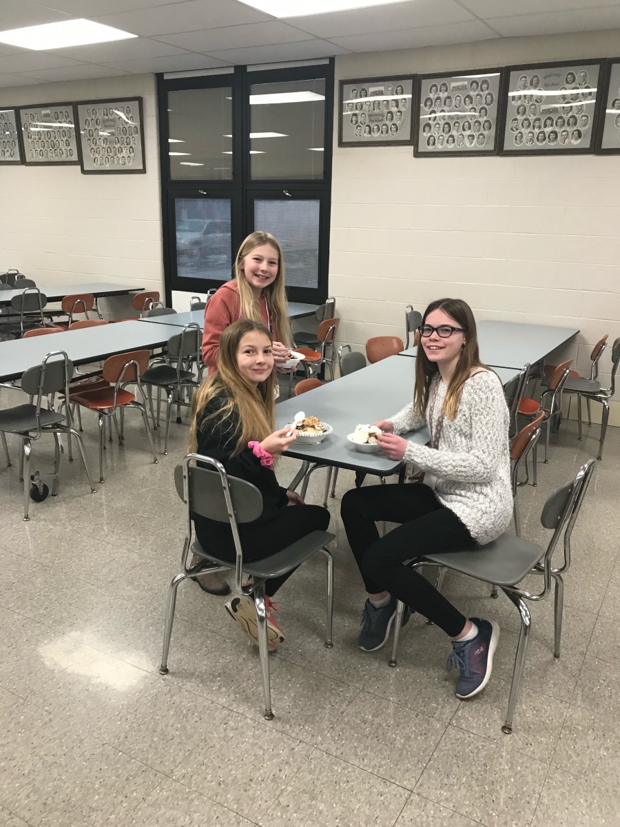 students at tables with bowls of ice cream